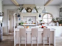 Modern white kitchen with natural Christmas decorations 
