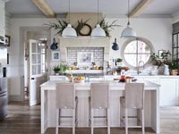 Modern white kitchen with natural Christmas decorations 
