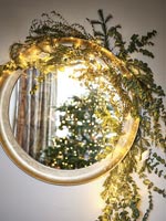 Christmas decorations around mirror 