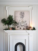 Painting of chandelier over classic fireplace 