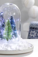 Snow globe with fake trees, fairy lights and cotton wool snow