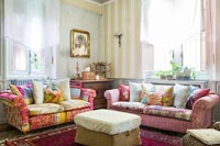 Country living room with patchwork patterned sofas 