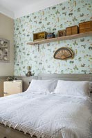 Patterned wallpaper in country bedroom 