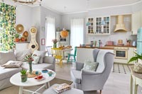 Modern open plan living space decorated in pastel colour scheme 