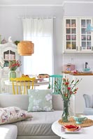 Small open plan living space decorated in pastel colours 