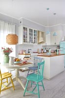 Kitchen diner in small open plan living space decorated in pastel colours 
