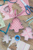Metal cookie cutters lined with patterned card and ribbons added for hanging