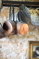 Copper pots and pans on hooks 