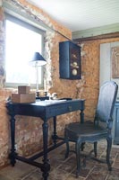 Black painted desk and chair in country study 