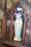 Religious ornament in ornate wooden and glass case 