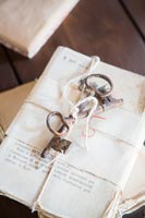 Vintage metal keys tied around pages of a book 