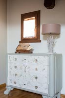 Decorative chest of drawers in country bedroom 