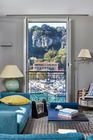 Modern living room with view of port from open French windows 