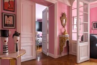 Sculptures in pink painted eclectic living room 