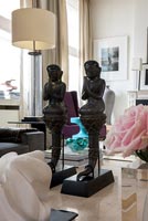 Pair of matching sculptures on coffee table 