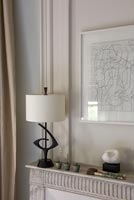 Black and white lamp on mantelpiece 