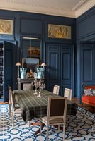 Dark blue painted panelled walls in classic style dining room 