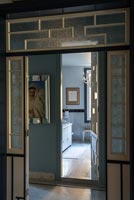 View through Art Deco style interior doors to bathroom beyond 