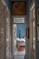 View through Art Deco style interior doors to bedroom beyond 
