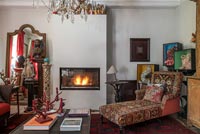 Lit fireplace in eclectic living room 