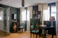 Dark grey painted wall and antique furniture 