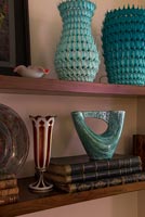 Teal ceramics on wooden shelf 