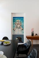 Painting on wall of modern dining room 