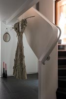 Dress hanging from contemporary staircase 