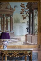 Ornate console table and large classic painting 