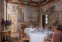 Fresco covered walls in classic dining room 
