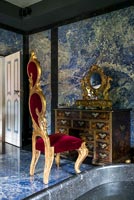 Red and gold throne chair in classic bathroom