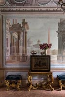 Ornate furniture next to fresco wall 