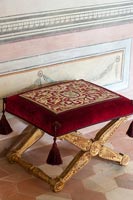 Red velvet and gold footstool 