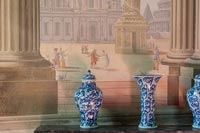 Blue and white vases next to fresco wall 