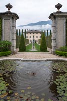Large pond in formal garden with view of grand house
