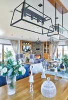 Modern dining area with blue accessories in open plan living space 