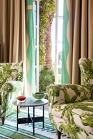 Green patterned fabric on armchairs in modern living room 