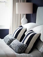 Patterned cushions and pillows on bed 