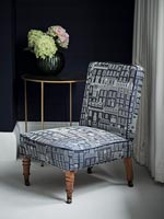 Patterned fabric on upholstered low chair 