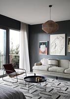 Modern living room with dark grey painted walls 