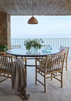 Round table and chairs on balcony with sea views 