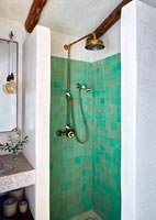 Green tiled shower in white country bathroom 