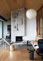 Contemporary living room with unusual textured concrete fireplace 