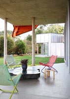Furniture on covered concrete terrace 