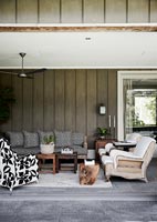 Modern country outdoor living room with eclectic furniture 