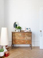 Wooden chest of drawers in bedroom 