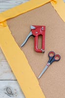 Tools and equipment for stapling fabric to cork board 