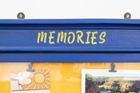 Yellow lettering - Memories - on frame of notice board 
