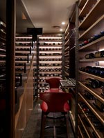 Chairs in small illuminated wine cellar 
