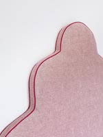 Detail of pink upholstered headboard